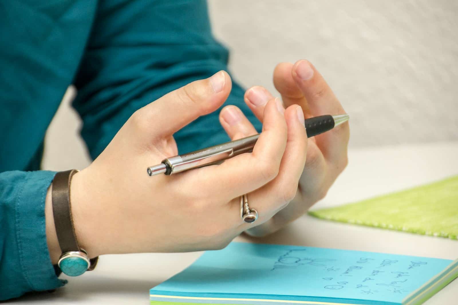 Photo by Julia Taubitz a person sitting at a table using a cell phone
